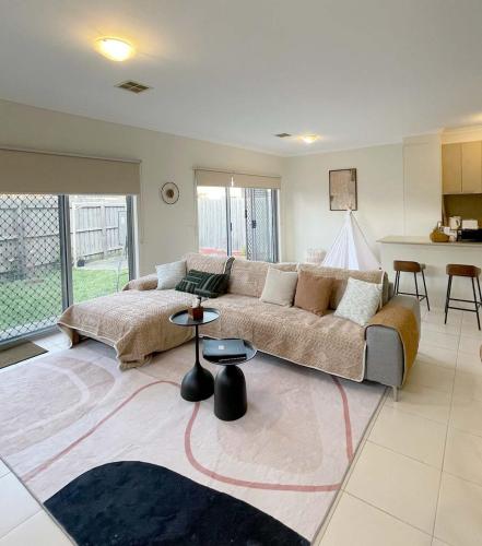 a living room with a large couch and a kitchen at Special offer! Jap-inspired stay with Lakeside view Room OR Entire House in Berwick