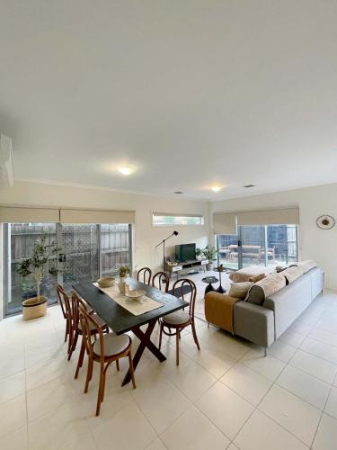 a living room with a table and a couch at Special offer! Jap-inspired stay with Lakeside view Room OR Entire House in Berwick