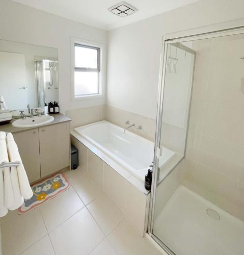 a bathroom with a shower and a tub and a sink at Special offer! Jap-inspired stay with Lakeside view Room OR Entire House in Berwick