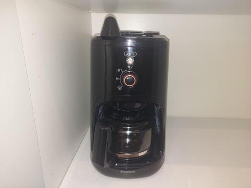 a black coffee maker sitting on a counter at n6天花 in Niseko