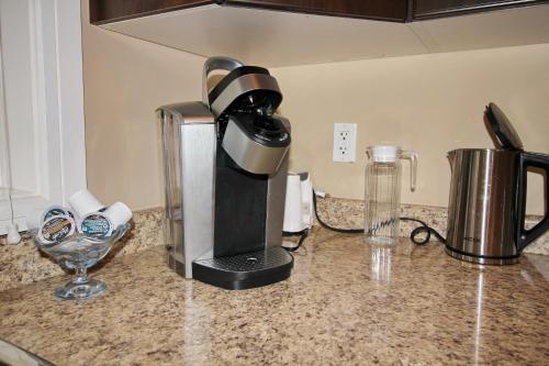 a coffee maker sitting on top of a kitchen counter at Close to YVR King Sized Private Entrance Suite in Richmond