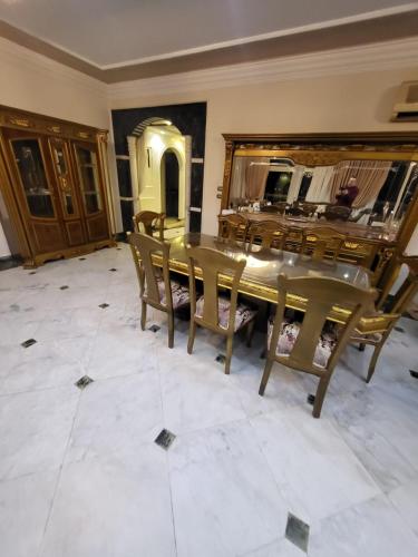 a dining room with a table and chairs at شقه فى ميامى بالاسكندريه مطله على البحر in Alexandria