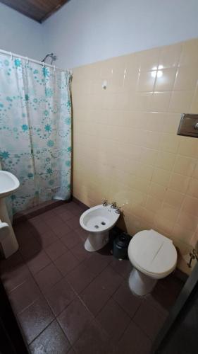 a bathroom with a toilet and a sink at Tu Lugar II in Colón