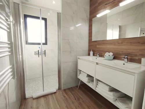a white bathroom with a sink and a shower at Gîte in Etretat near Cliffs & Beach in Bordeaux-Saint-Clair