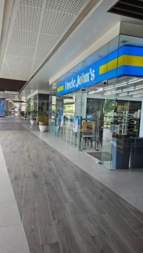 an empty shopping mall with a blue and yellow sign at Cozy Studio at Baseline Prestige in the Heart of Cebu City in Cebu City