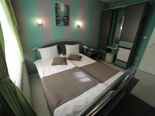 Postel nebo postele na pokoji v ubytování Hotel Ženeva
