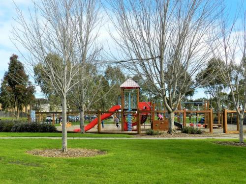 a playground with a red slide in a park at Special offer! Jap-inspired stay with Lakeside view Room OR Entire House in Berwick