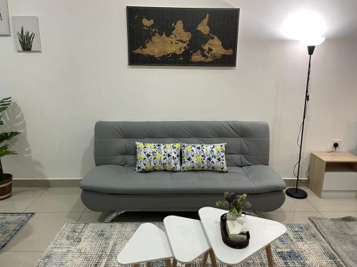 a living room with a couch and a table at Amir's Cozyhouse Seksyen14 -WIFI & NETFLIX- in Shah Alam