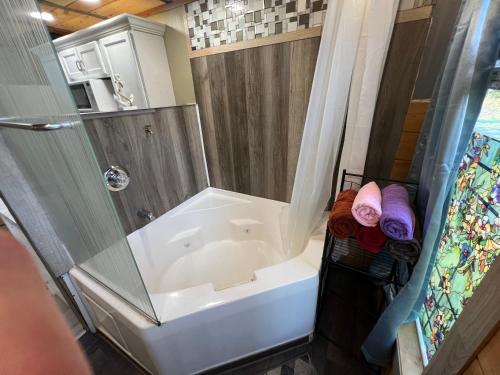 a bathroom with a shower and a white tub at Stoney Mtn High-duh-way 420&Pets yes in Gatlinburg