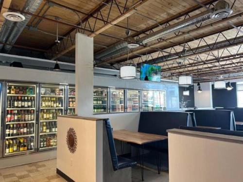 a restaurant with a table and a lot of drinks at Parkside Inn in Grande Prairie