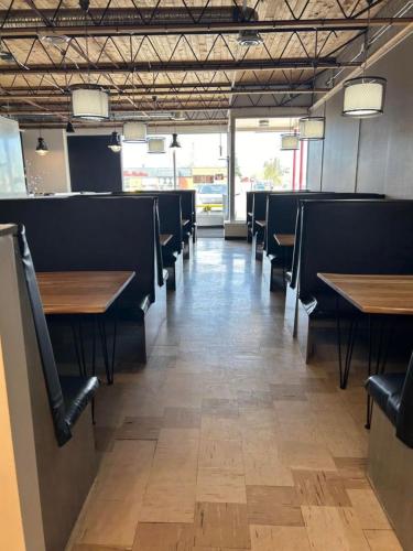 a dining room with wooden tables and chairs at Parkside Inn in Grande Prairie