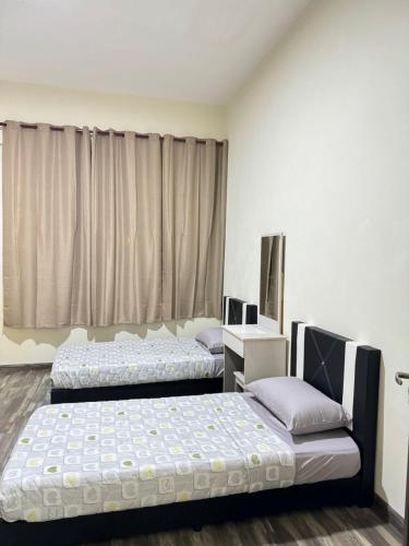 Postel nebo postele na pokoji v ubytování Wong Homestay