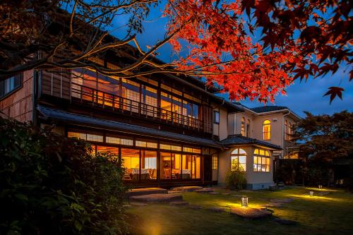 a house with large windows at night at Hotel Utano Kyoto Besho in Kyoto