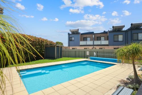 a swimming pool in front of a house at Beach Life at Cowes in Cowes