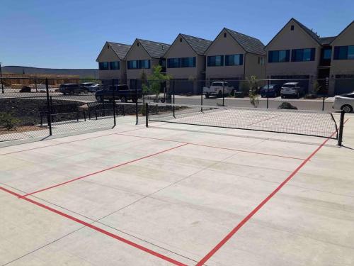 a tennis court with a net in a parking lot at Luxury Red Rock Townhome - 42- St George Santa Clara in Santa Clara