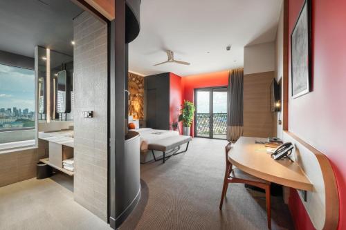 a room with a dining table and a bathroom at SUN & MOON, Riverside Hotel in Phnom Penh