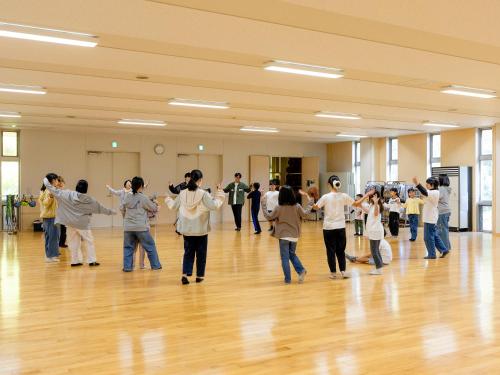 a group of people dancing in a hall at Labo Land Kurohime in Shinano