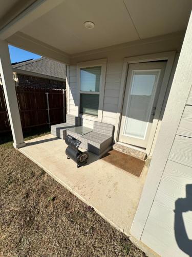 a porch with a bench on a house at Cozy Room in a quiet house for professionals / Business Travel in Aubrey