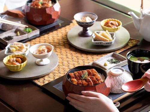 a table topped with dishes of food on plates at Labo Land Kurohime in Shinano