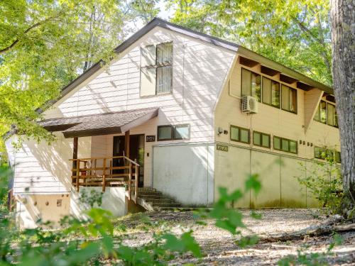 a house with a garage and trees at Labo Land Kurohime in Shinano
