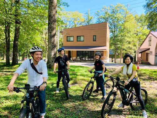 a group of people on bikes in the grass at Labo Land Kurohime in Shinano