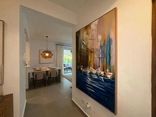 a large painting on the wall in a hallway at Luxury 2 Bedroom Apartment, 1 Min Walk to Punta Popy Beach, Pool, AC, Fast WiFi, Las Terrenas in Las Terrenas