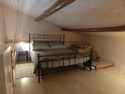a bedroom with a metal bed in a attic at Stefy House in Lastra a Signa