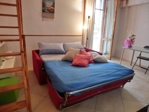 a bed with pillows on it in a room with a ladder at Stefy House in Lastra a Signa