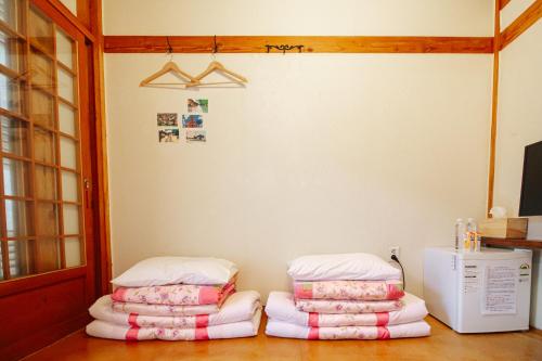 a room with two stacks of pillows on the floor at Jeonju Hanok village Deoksugung in Jeonju