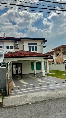 a white house with a driveway in front of it at no7 HOMESTAY in Tanjung Karang