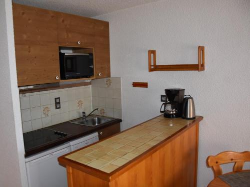 une cuisine avec un évier et un plan de travail dans l'établissement Studio cabine centre station, proche remontées - FR-1-464-246, à Champagny-en-Vanoise