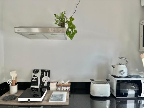 a kitchen with a counter top with a stove top oven at Borbaimai home in Chiang Rai