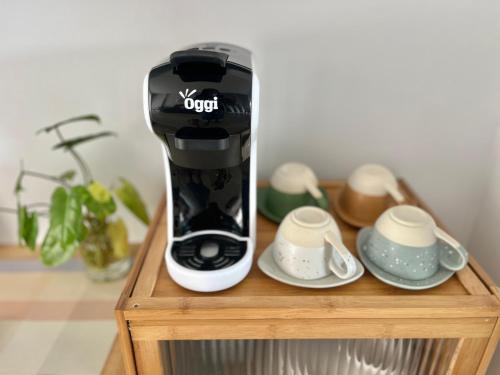 a black and white coffee maker on a wooden stand at Borbaimai home in Chiang Rai