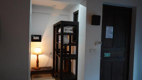 a hallway with a room with a door and a lamp at Amaluna Resorts in Negombo