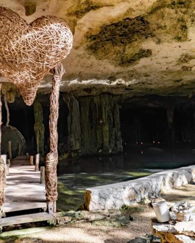 a statue of a giraffe standing in a cave at Loft Cabins In Cenotes Natural Park Tulum in Tulum