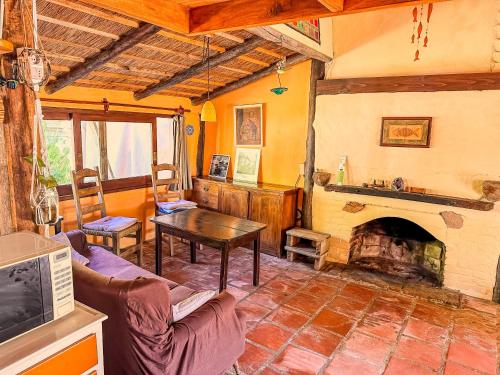 a living room with a couch and a fireplace at Yrupa in Barra de Valizas