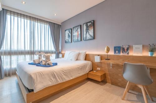 Giường trong phòng chung tại Pattaya Holiday at Veranda Residence Pattaya
