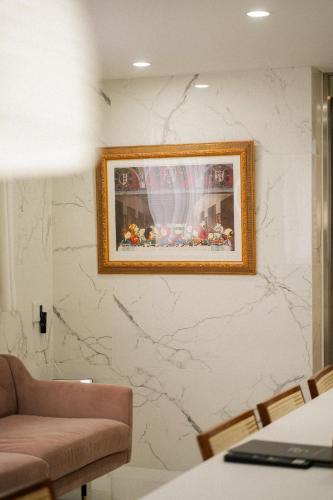 a living room with a picture on the wall at THE ROOT2 HOTEL in Kyoto