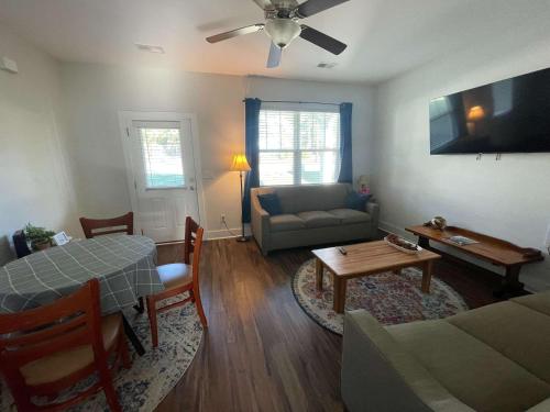 a living room with a couch and a table at The Capital Cottage New Home Near USC & Bases in Columbia
