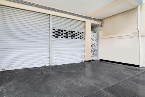 a garage with white doors and a tile floor at Hotel O LAHARI LUXURY ROOMS in Warangal