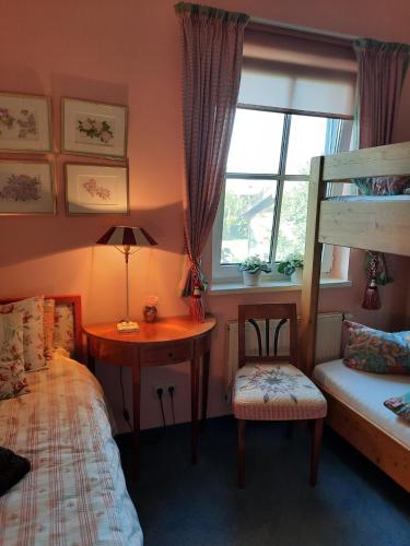 a bedroom with a bed and a desk and a bunk bed at Das Landhaus Oberstdorf in Oberstdorf