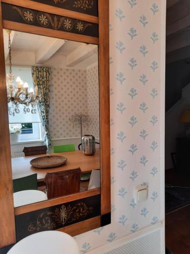 a mirror in a kitchen with a table at Das Landhaus Oberstdorf in Oberstdorf