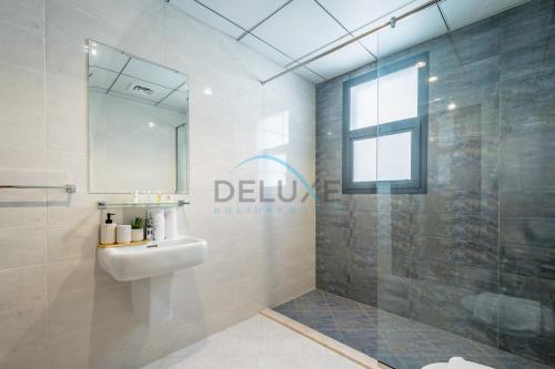 a bathroom with a sink and a shower at Getaway Offer with Pool, BBQ & Picturesque Views by Deluxe Holiday Homes in Fujairah