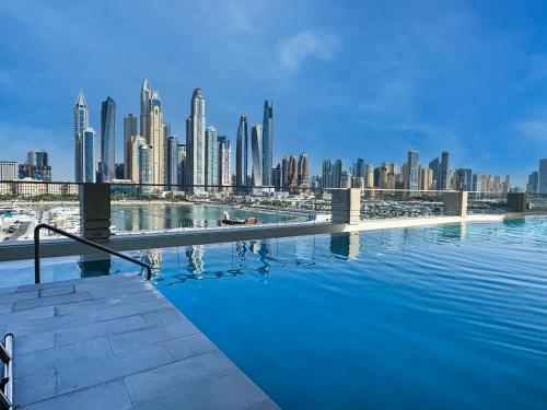 a swimming pool with a view of a city at Chic 1 Bedroom on Private Beach in Dubai Harbour in Dubai
