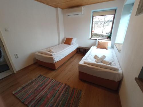 a small room with two beds and a window at Vedra Guest House in Ganchovets