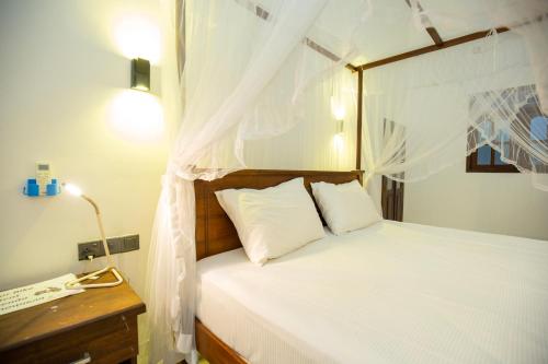 Ένα ή περισσότερα κρεβάτια σε δωμάτιο στο Paradise cove Apartment