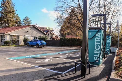 a parking lot with a handicapped sign on a street at Campanile Annecy - Cran Gevrier in Annecy