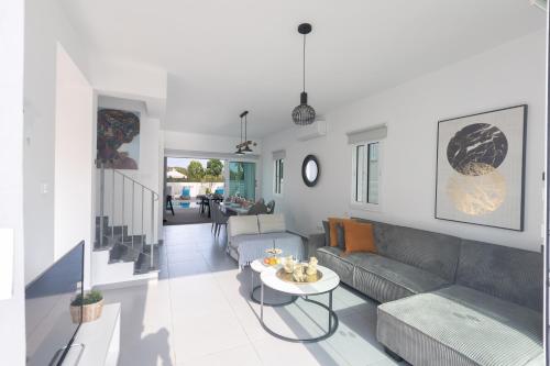 a living room with a couch and a table at Casa de Nicole in Protaras