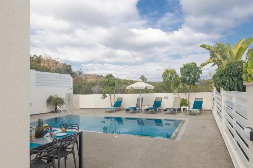 a pool with chairs and a table on a patio at Casa de Nicole in Protaras