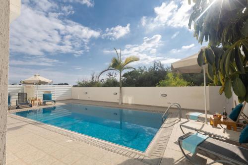 a large swimming pool with a white fence at Casa de Nicole in Protaras